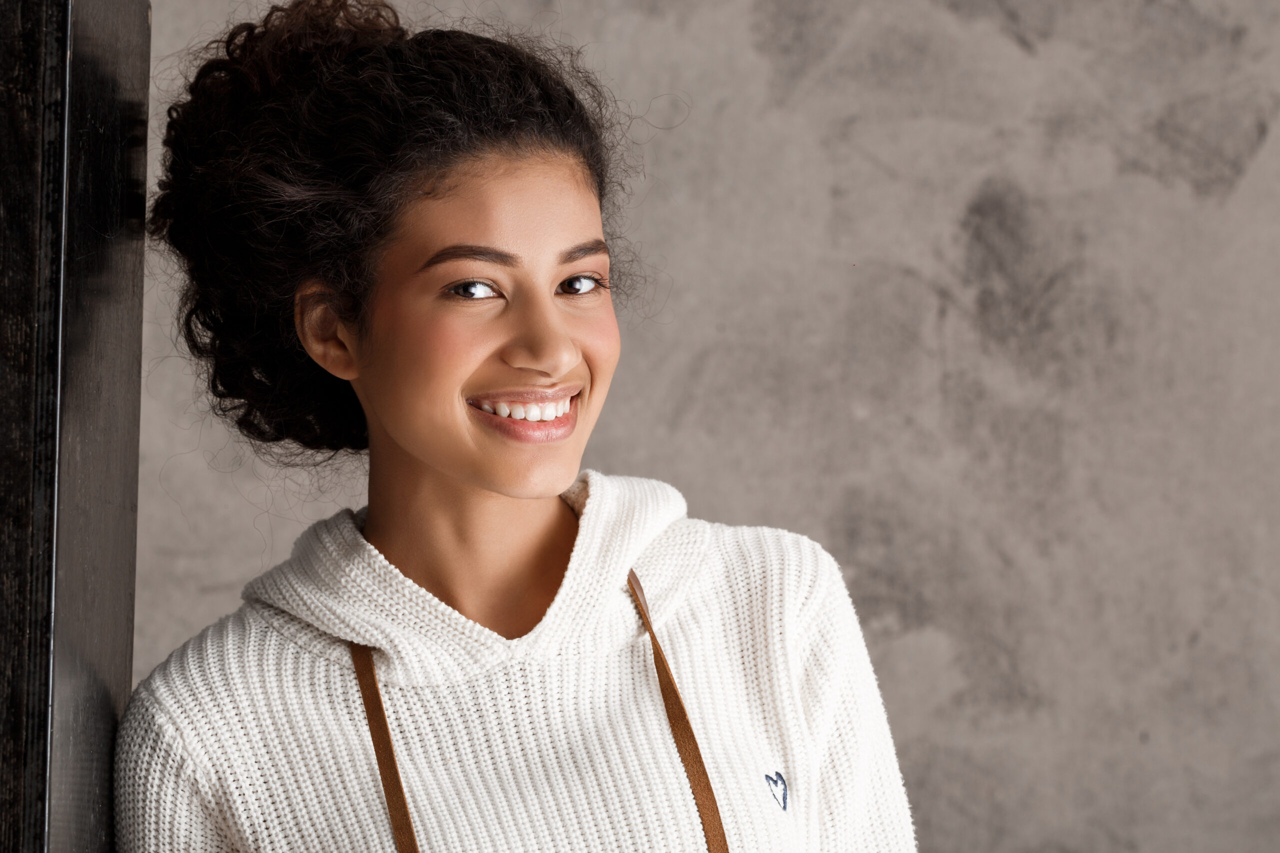 cute smiling curly woman lean wall scaled